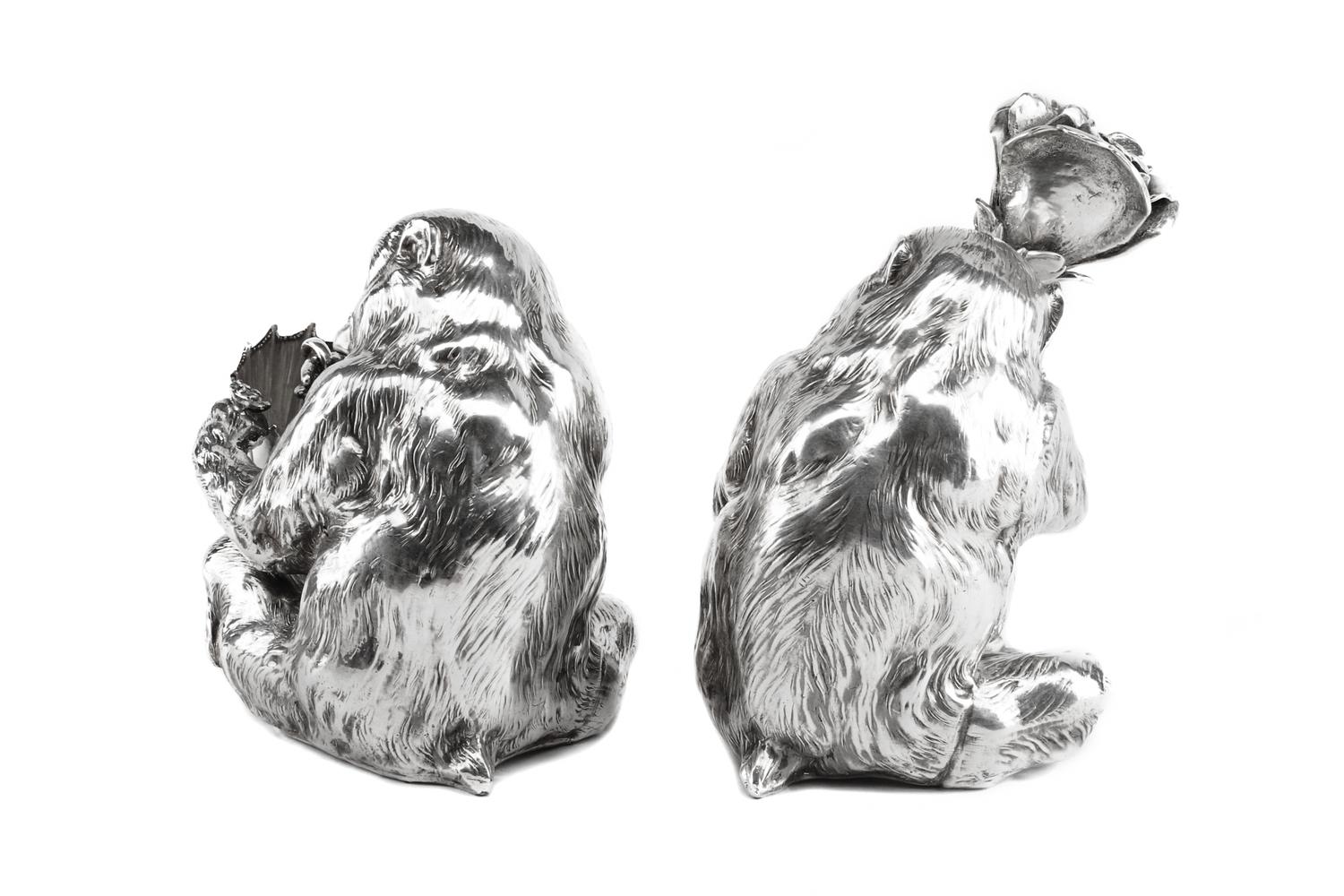 A Pair of Italian Silver-Plate Monkey Figures, Mid-20th Century, each in the form of a seated monkey, one figure holding an umbrella an
