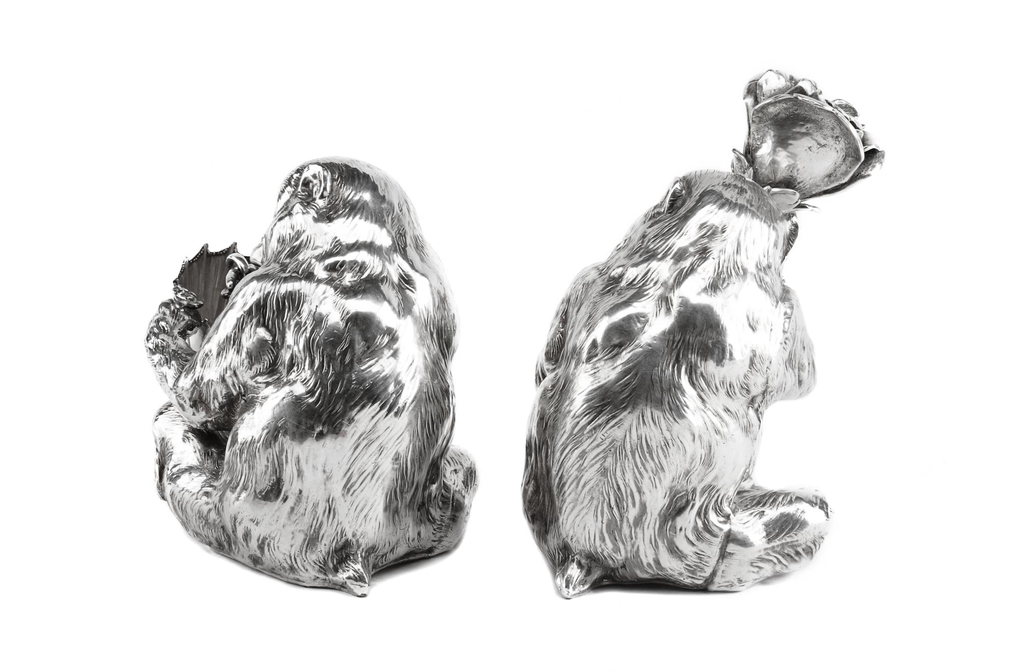 A Pair of Italian Silver-Plate Monkey Figures, Mid-20th Century, each in the form of a seated monkey, one figure holding an umbrella an