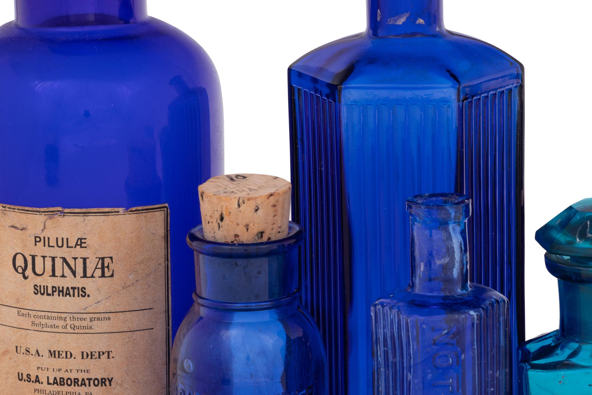 A Group of Blue Glass Apothecary Bottles
