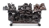 A Carved Zitan Figural Composition Width 25 inches.
