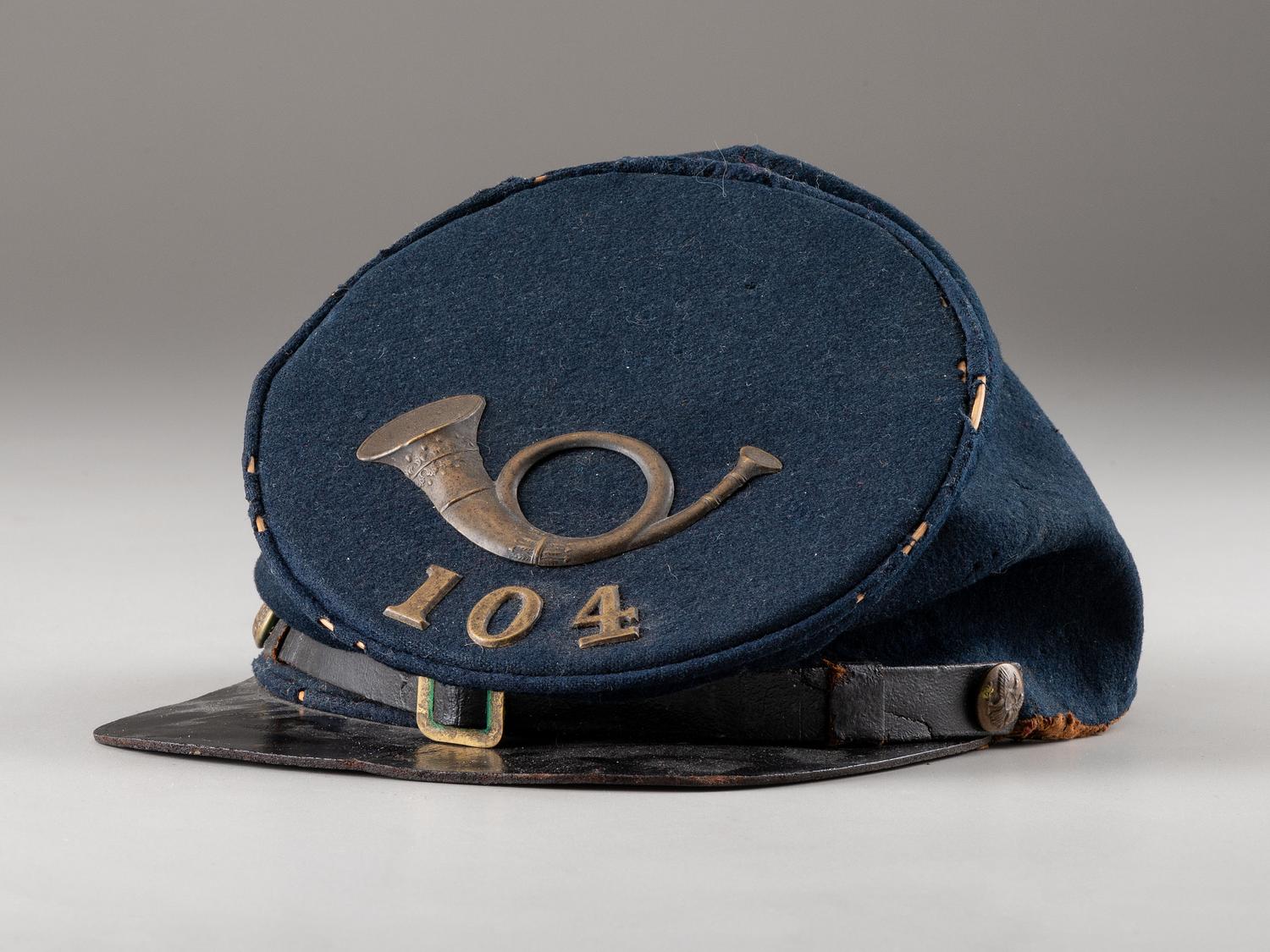 [CIVIL WAR]. Forage cap with contractor label featuring 104th regimental number and insignia.