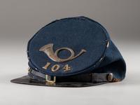 [CIVIL WAR]. Forage cap with contractor label featuring 104th regimental number and insignia.