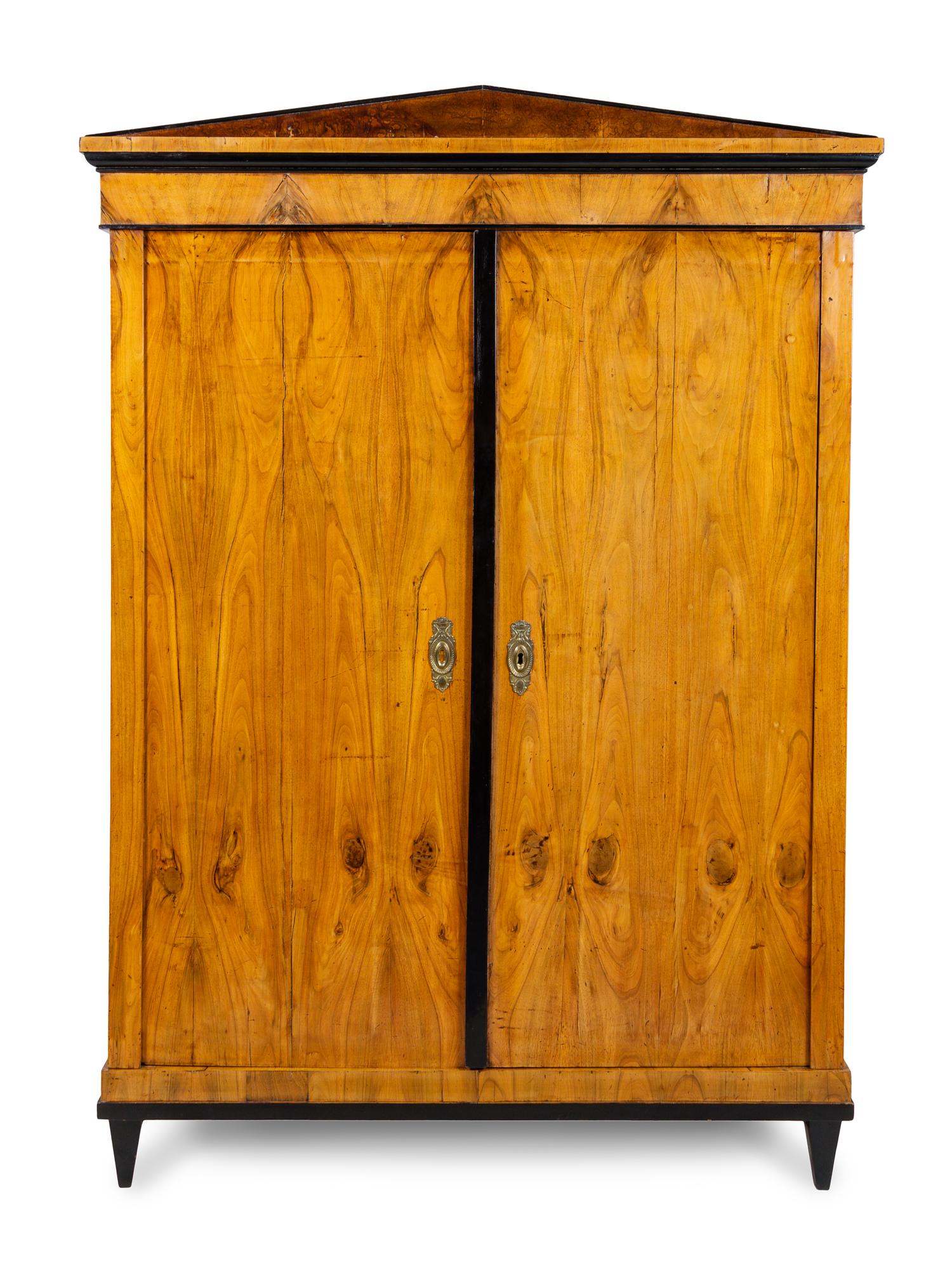 A Biedermeier Parcel Ebonized Walnut Armoire