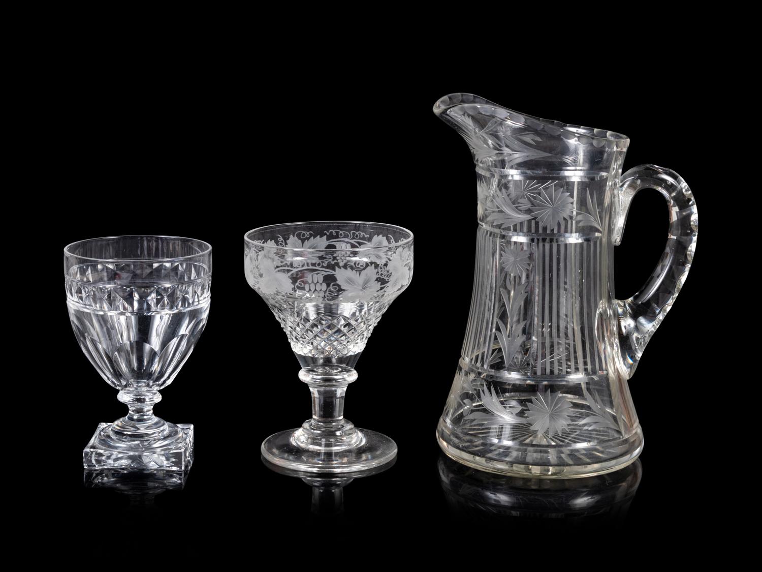 A Collection of Cut and Etched Glass Stemware and a Pitcher