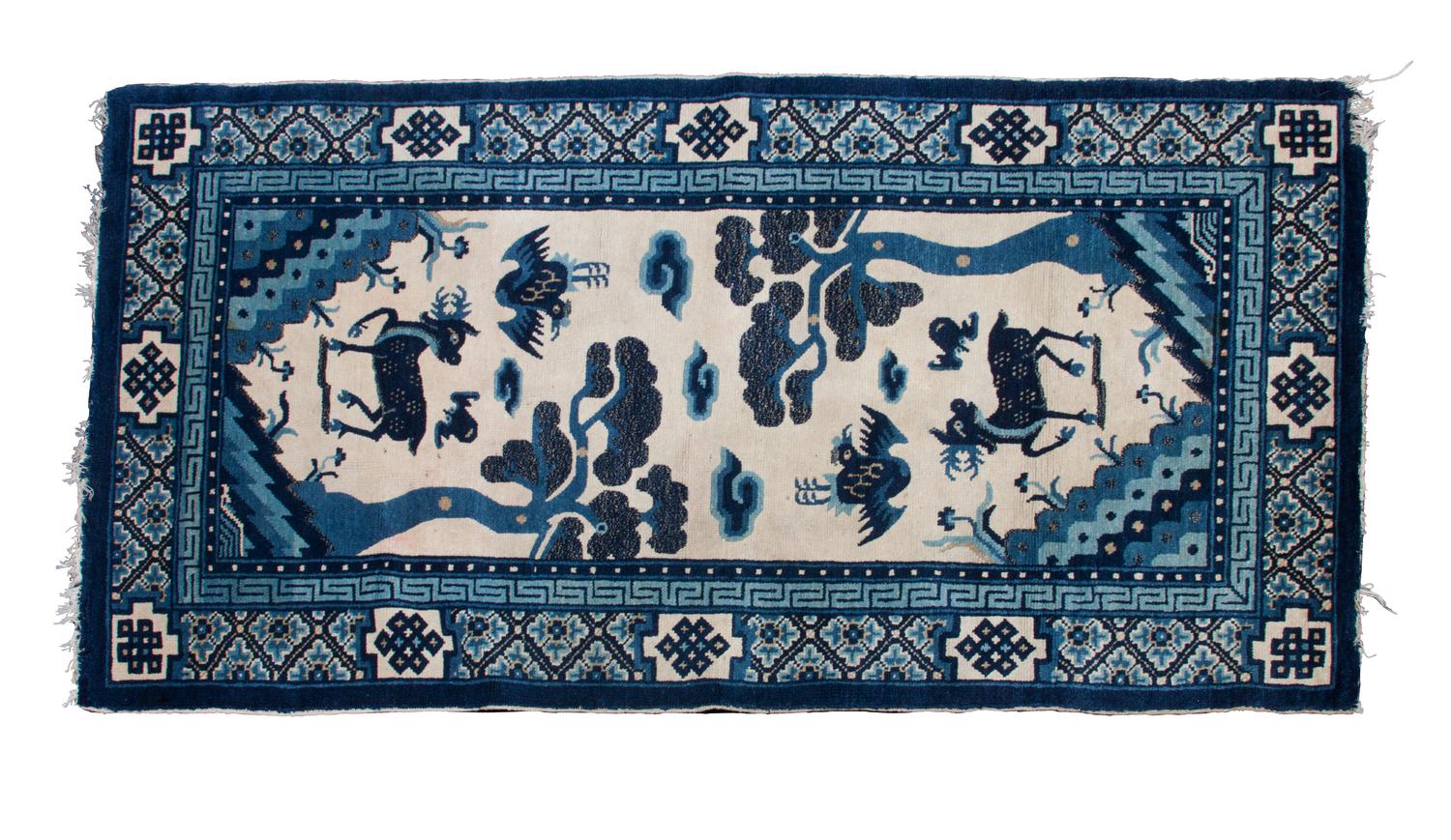 A Kansu Rug 4 feet 11 3/4 inches x 2 feet 7 inches.