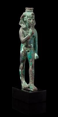 An Egyptian Bronze Striding Harpokrates Height 5 3/4 inches. — LATE PERIOD, DYNASTY 26-30, 664-343 B.C.E.