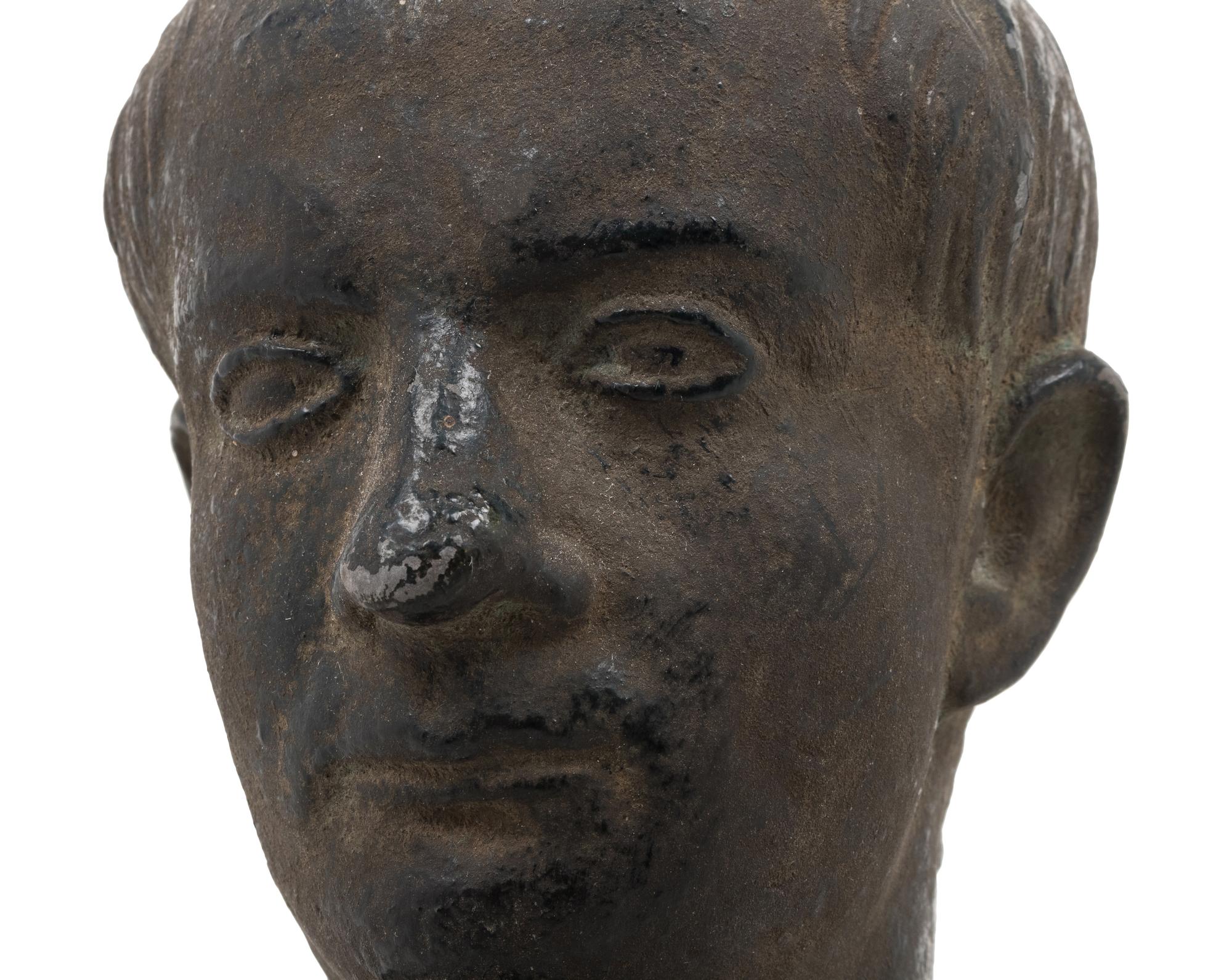 A Cast Metal Bust of a Man