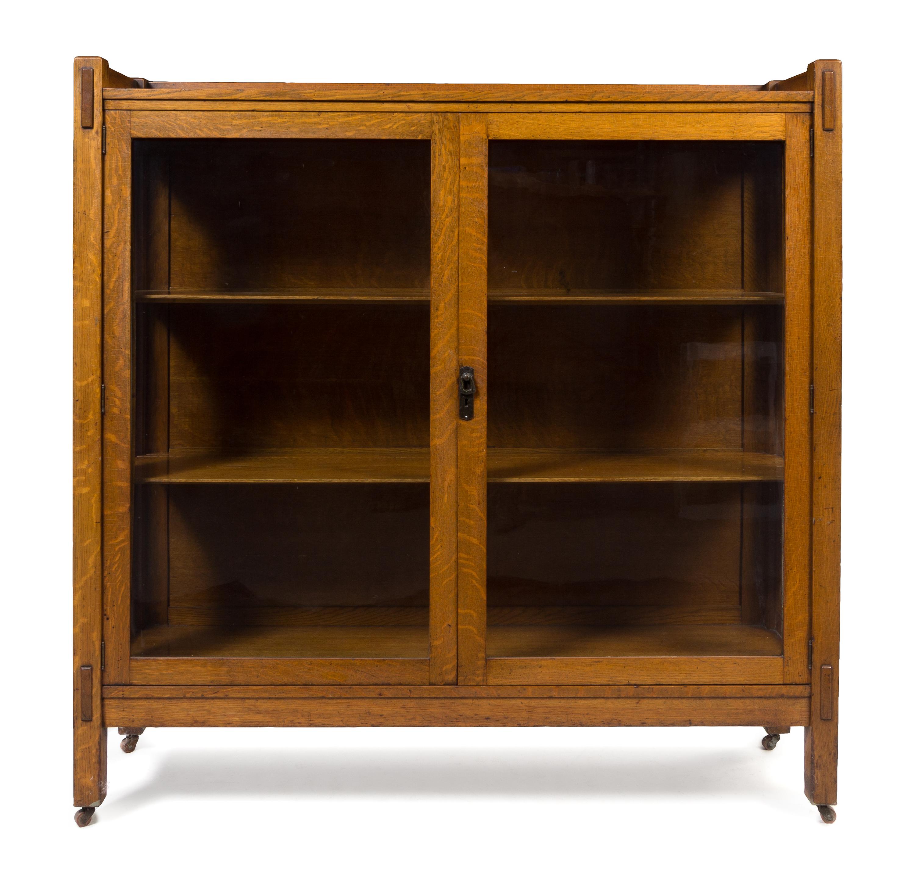 Arts and Crafts, FIRST HALF 20TH CENTURY, bookcase, having three-quarter galleried top over two glazed doors