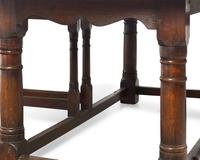 A Large Baroque Style Oak Drop-Leaf Dining Table