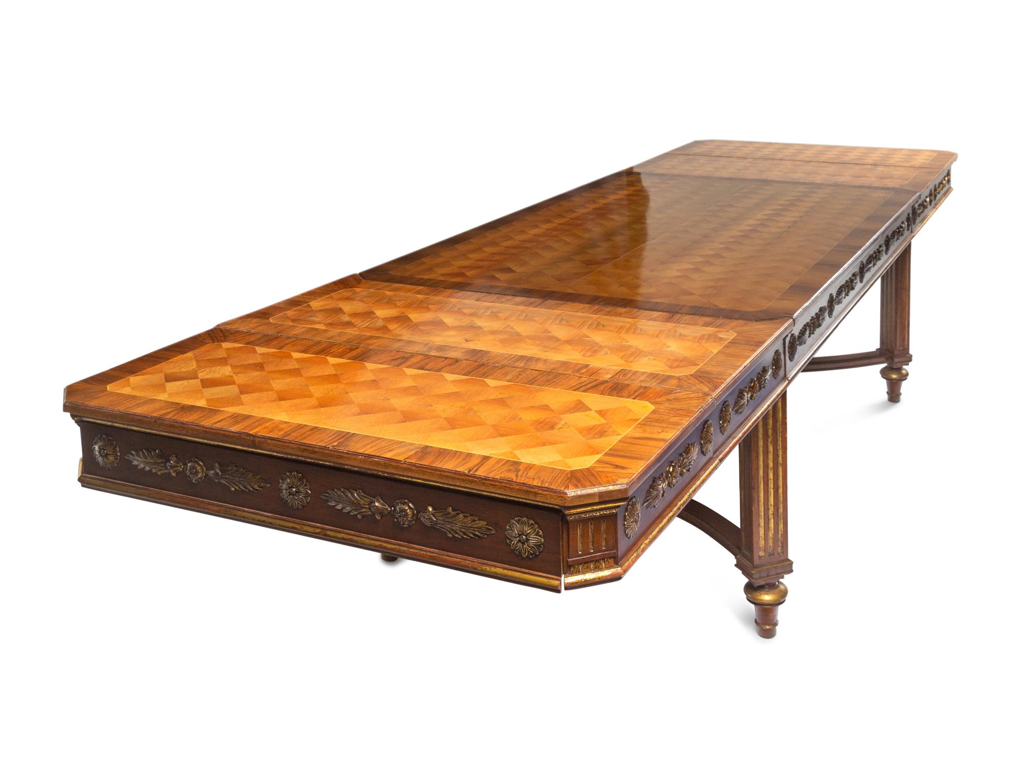 A Louis XVI Style Parcel Gilt Parquetry and Walnut Dining Table