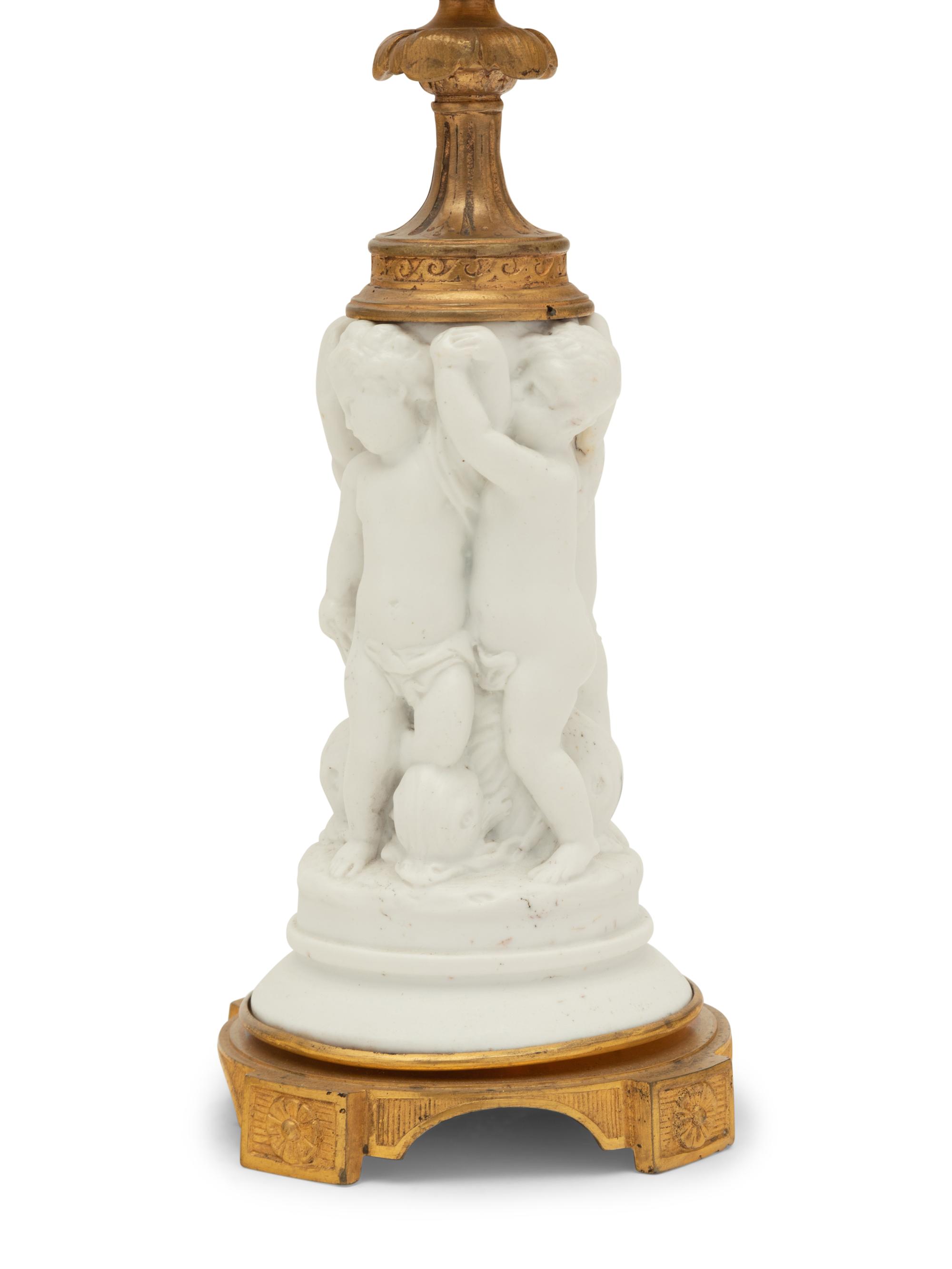 A Pair of Gilt Metal Mounted Bisque Porcelain Figural Ornaments