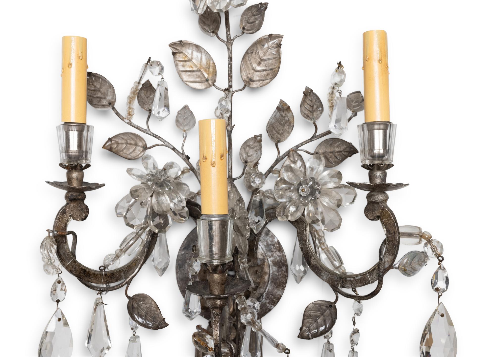 A Pair of Silvered Metal and Glass Three-Light Sconces in the Style of Maison Baguès