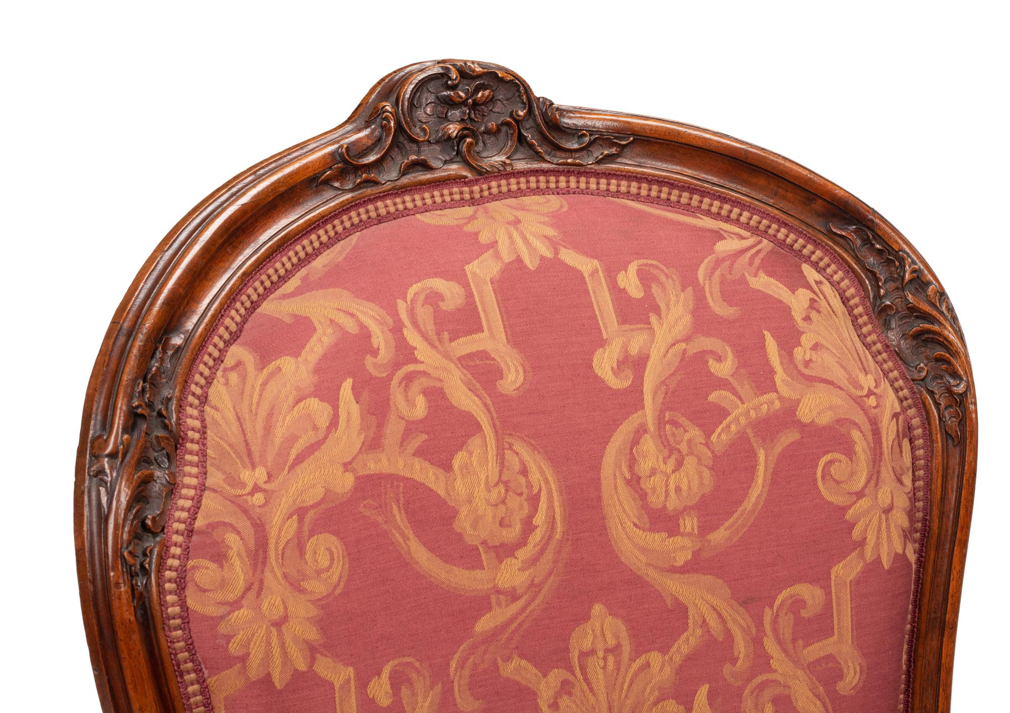 A Pair of Louis XV Style Carved Walnut Fauteuils