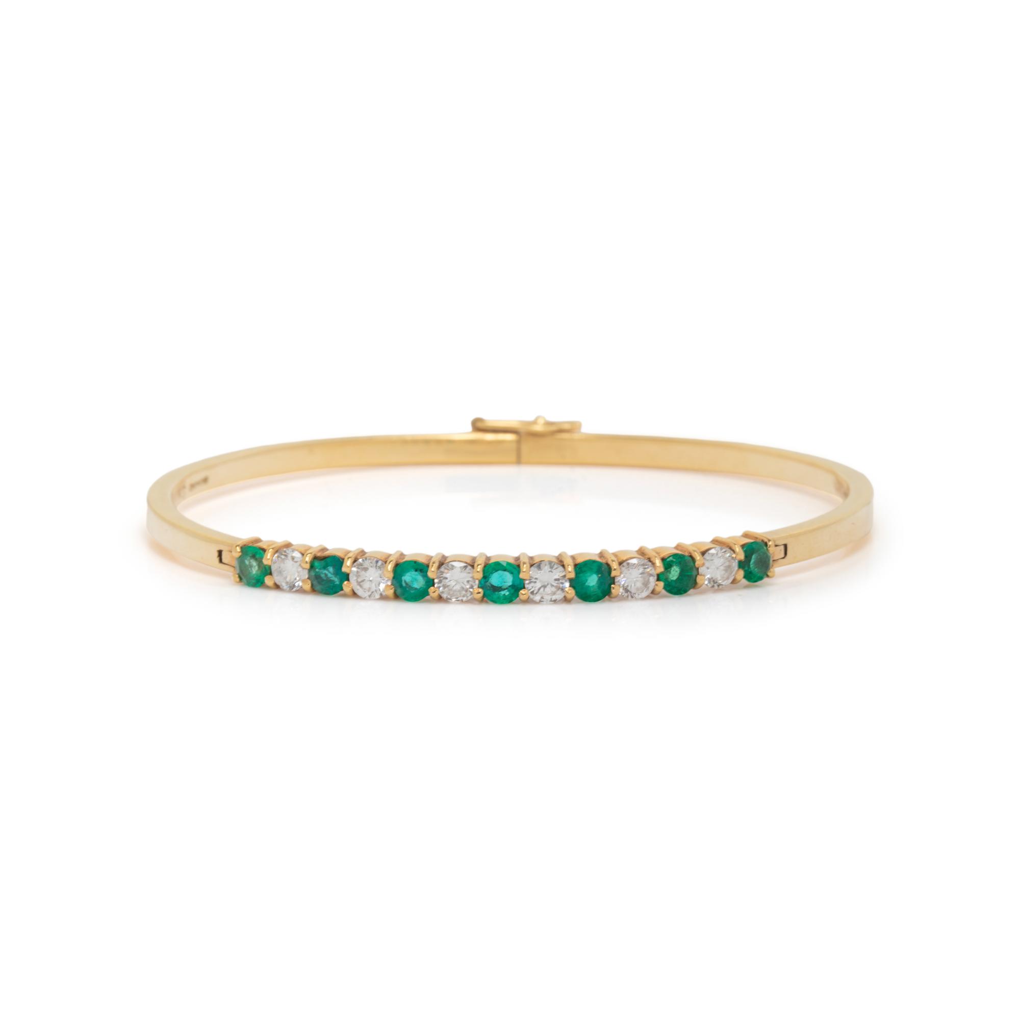 DIAMOND, EMERALD, AND YELLOW GOLD BANGLE BRACELET