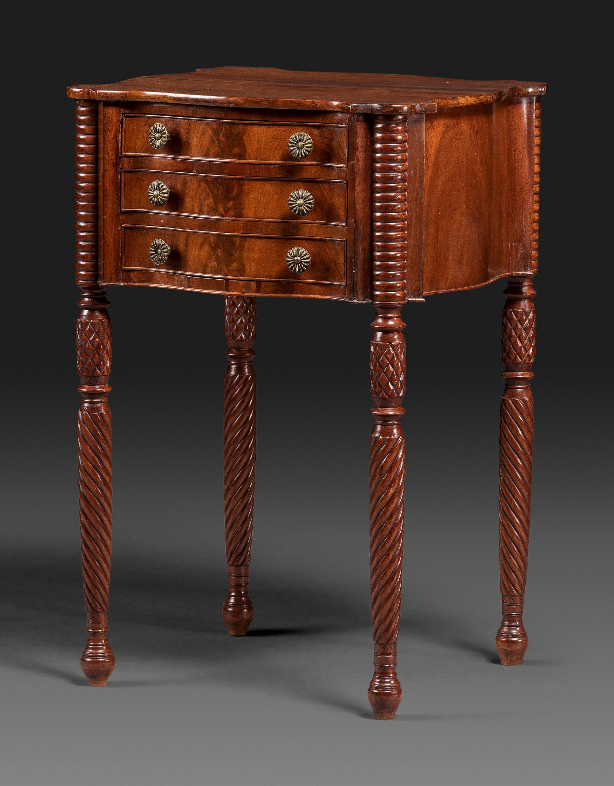 A Classical Carved Mahogany Three Drawer Work Table
