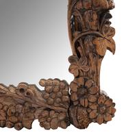 A Continental Carved Oak Mirror