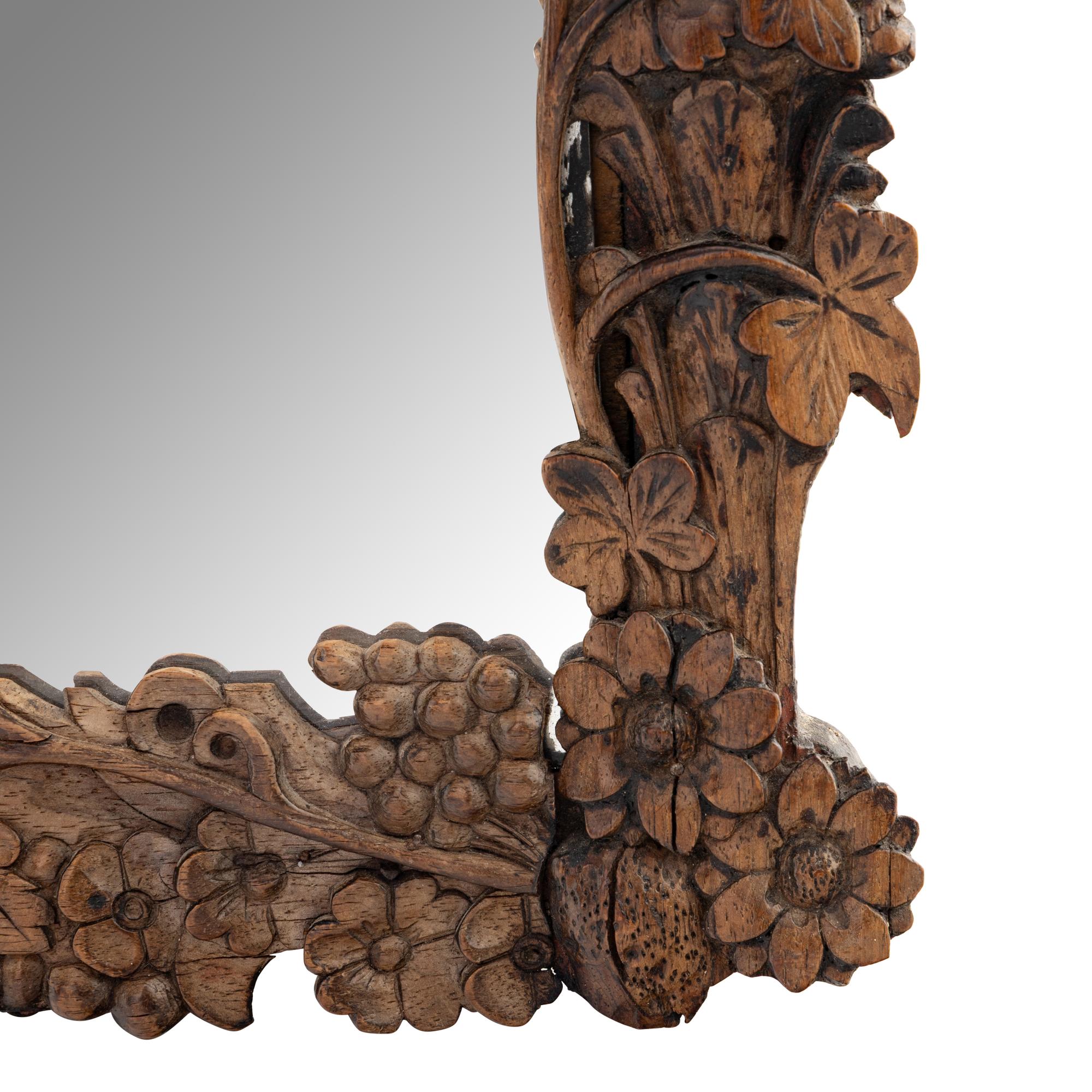 A Continental Carved Oak Mirror