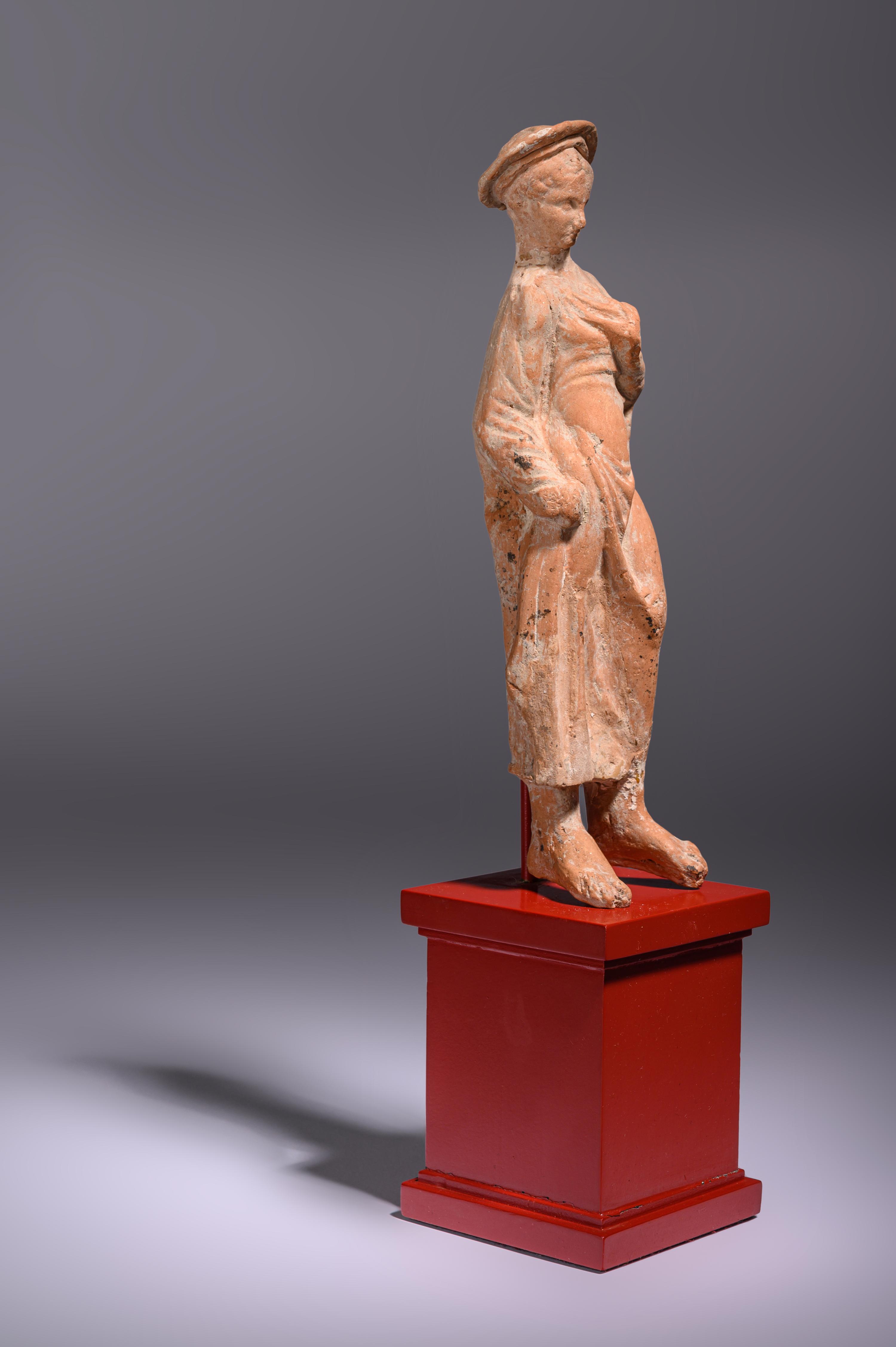 A Greek Terracotta Woman Wearing a Polos (broad-rimmed hat)