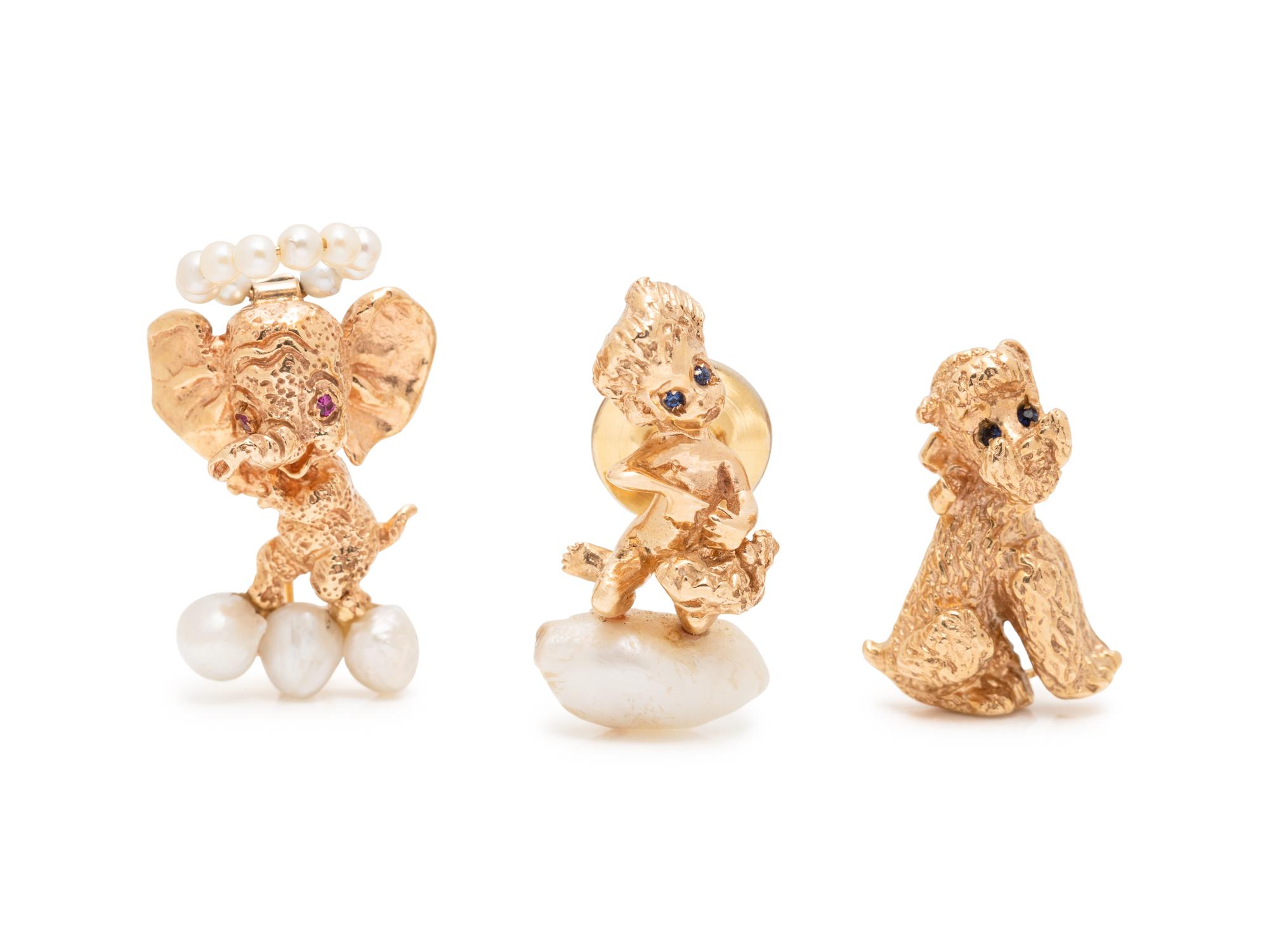 RUSER, A COLLECTION OF YELLOW GOLD BROOCHES