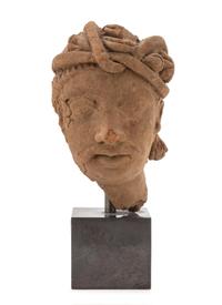 A Gandharan Terra Cotta Head of a Bodhisattva Height of head 8 inches. — HADDA REGION, 2ND CENTURY C.E.