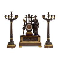 An Empire Style Gilt and Patinated Three-Piece Clock Garniture