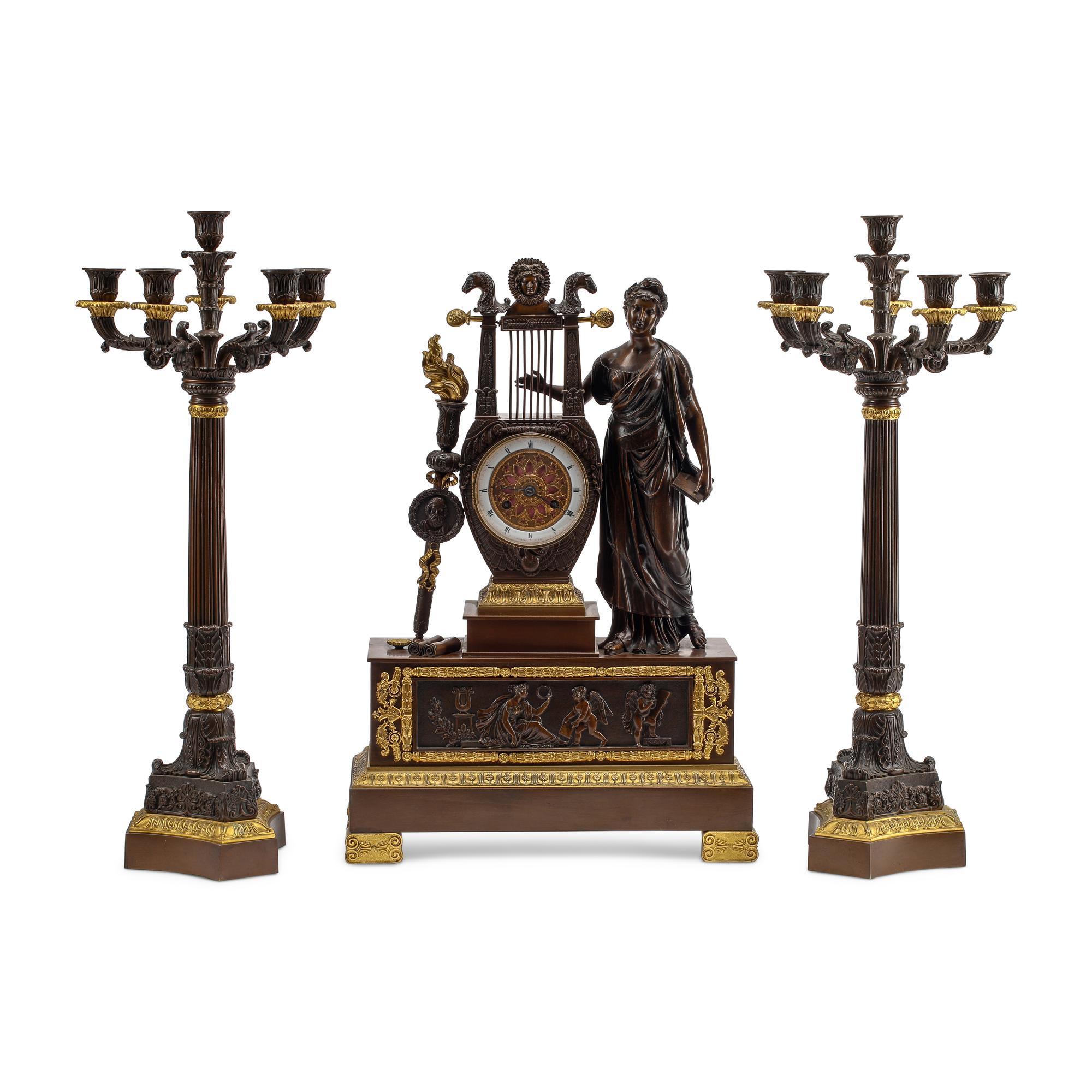 An Empire Style Gilt and Patinated Three-Piece Clock Garniture