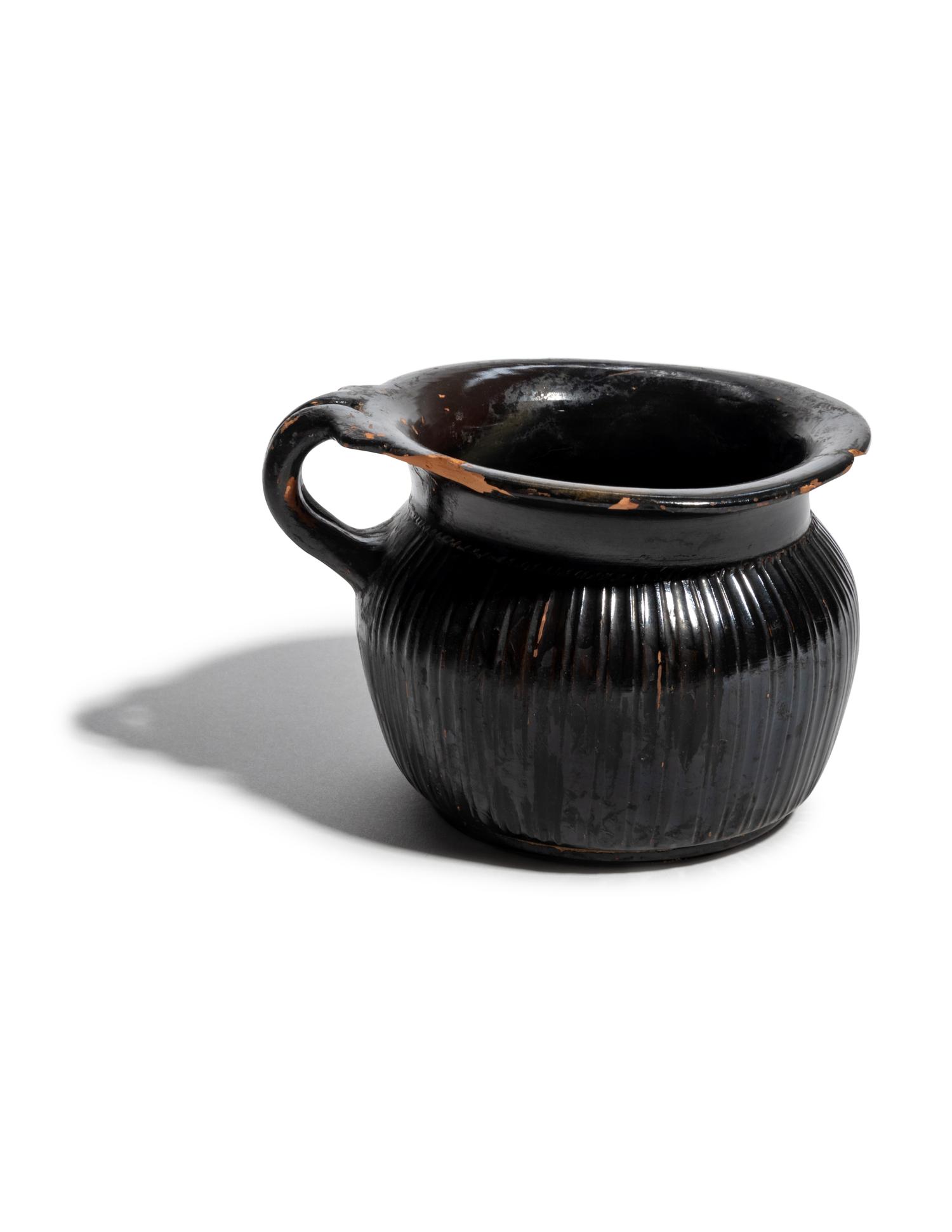A Greek Black-Glazed Ribbed Mug