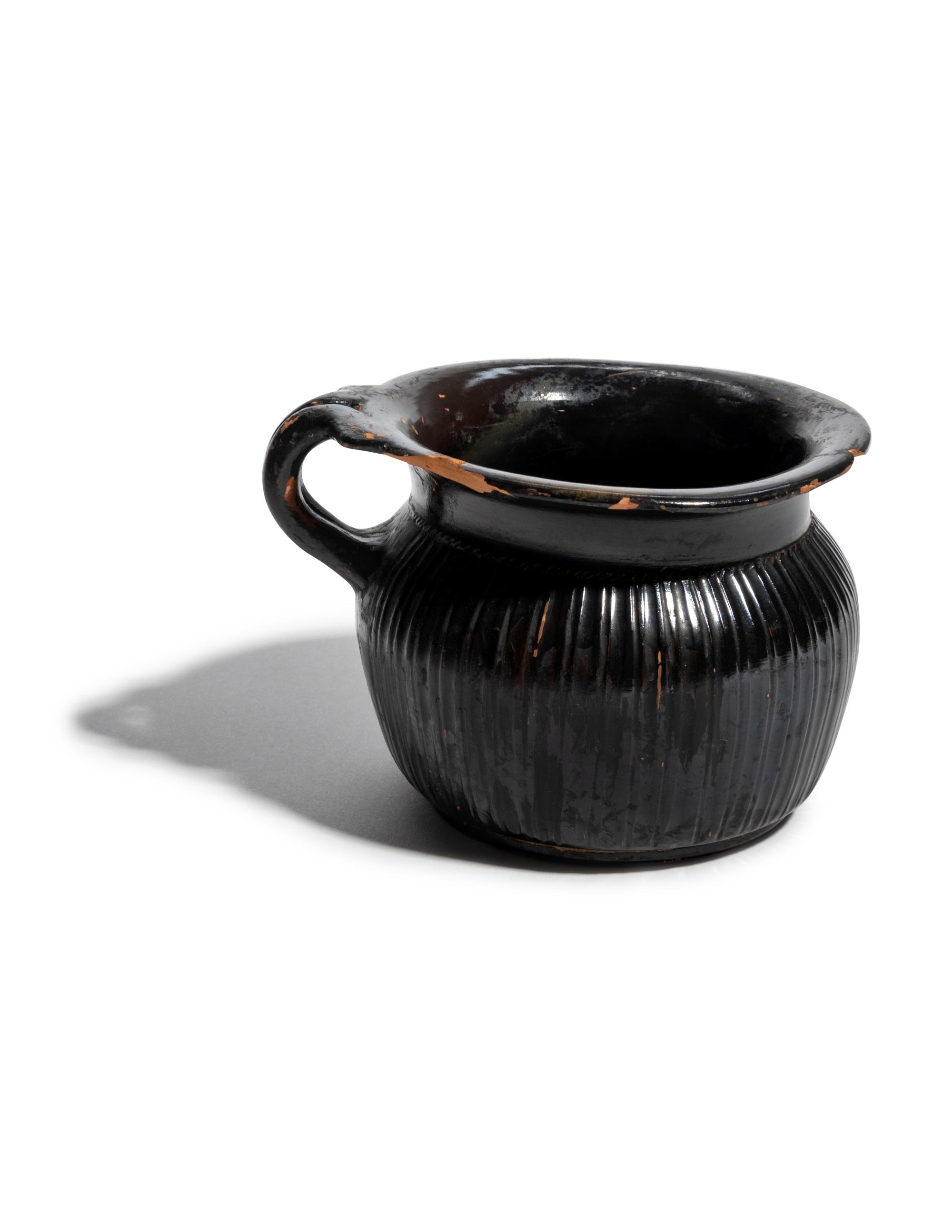 A Greek Black-Glazed Ribbed Mug