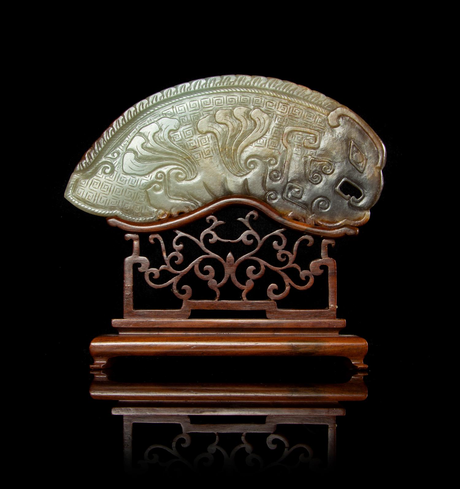A Large Russet and Celadon Jade Phoenix-Form Plaque