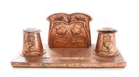 An Arts and Crafts Hammered Desk Stand Width 12 inches. — EARLY 20TH CENTURY
