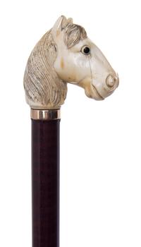 An Ivory Carved Handled Cane, Length of handle 2 1/4 x length overall 34 1/2 inches.