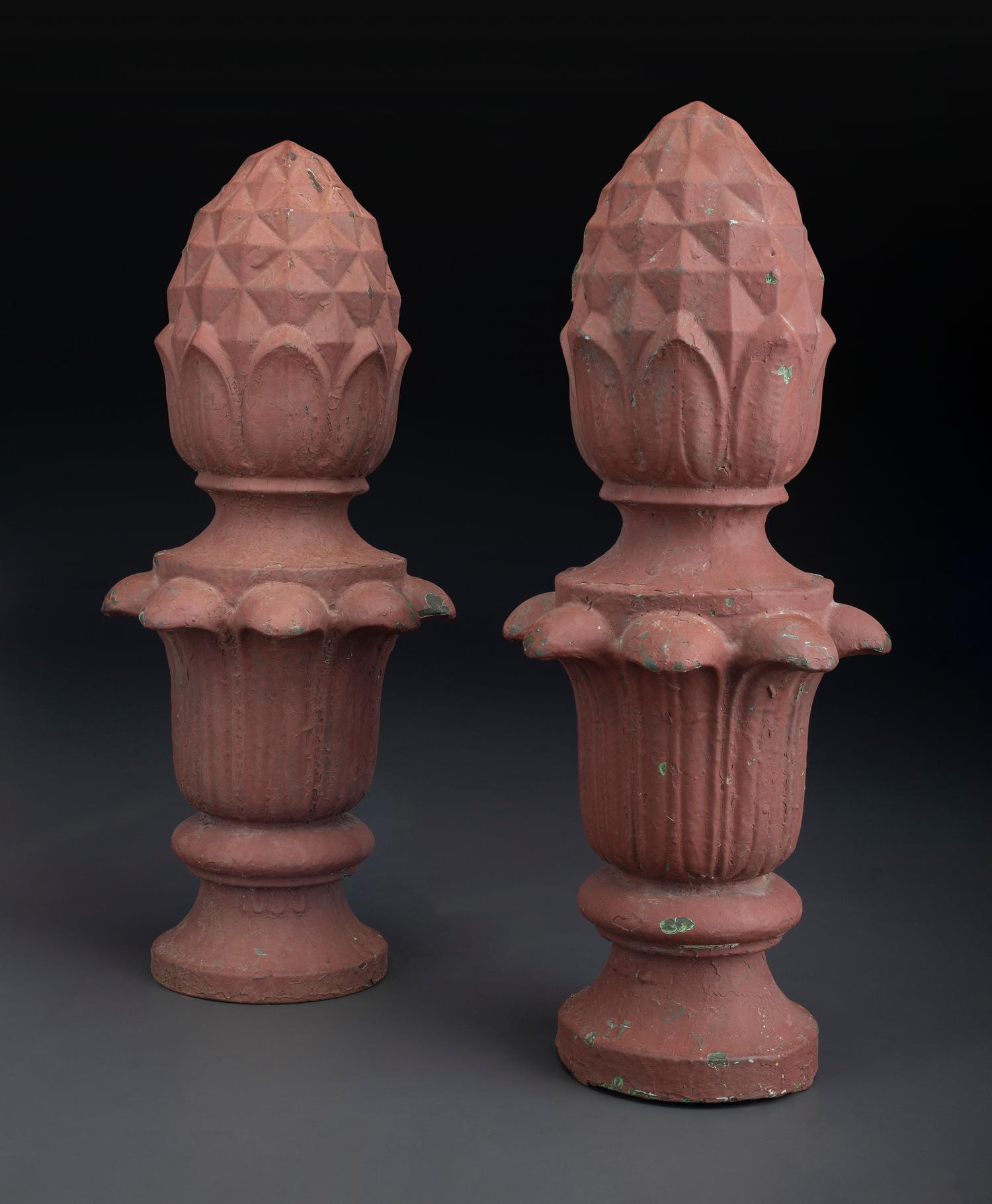 A Pair of Red Painted Cast Iron Architectural Finials