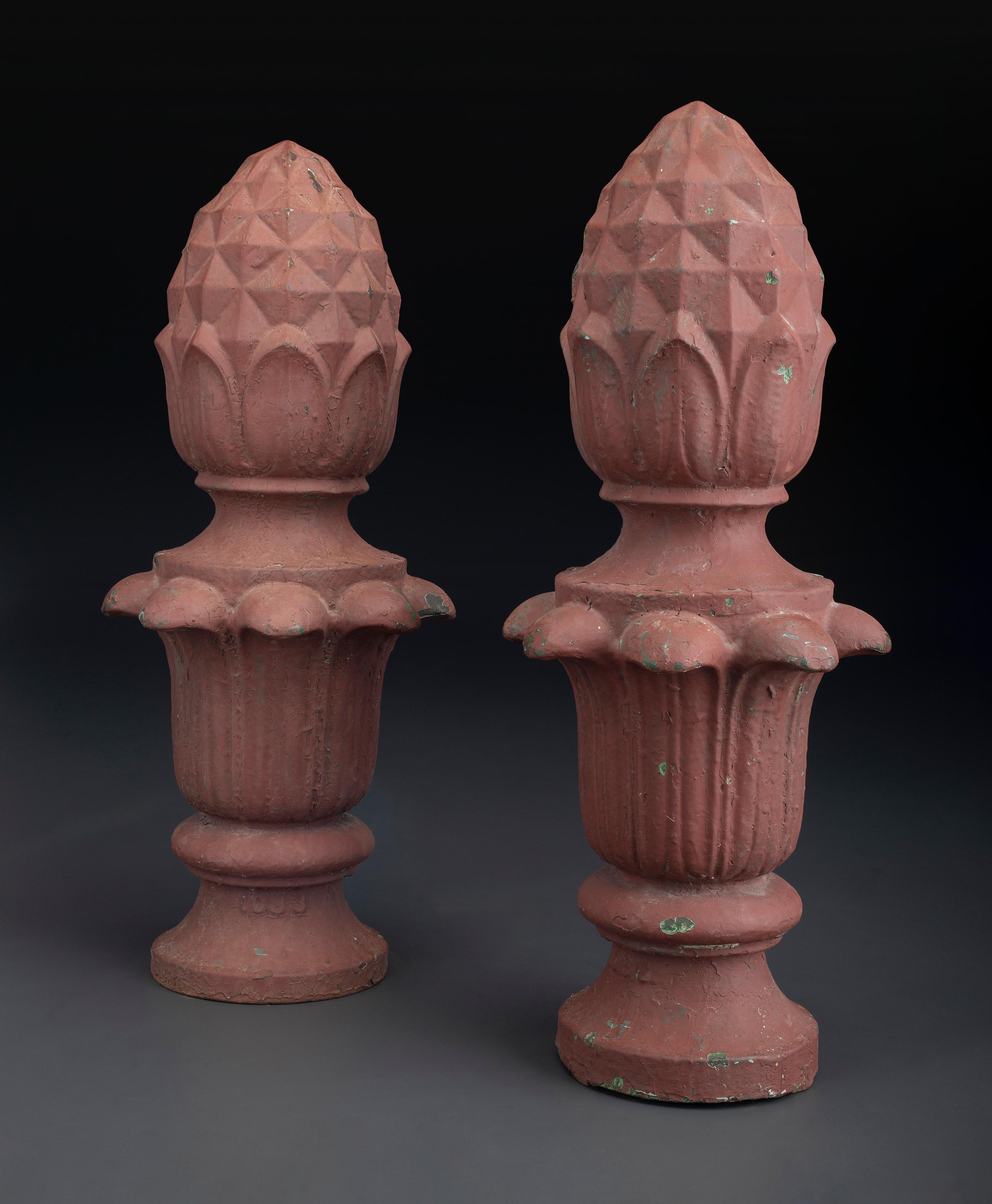 A Pair of Red Painted Cast Iron Architectural Finials