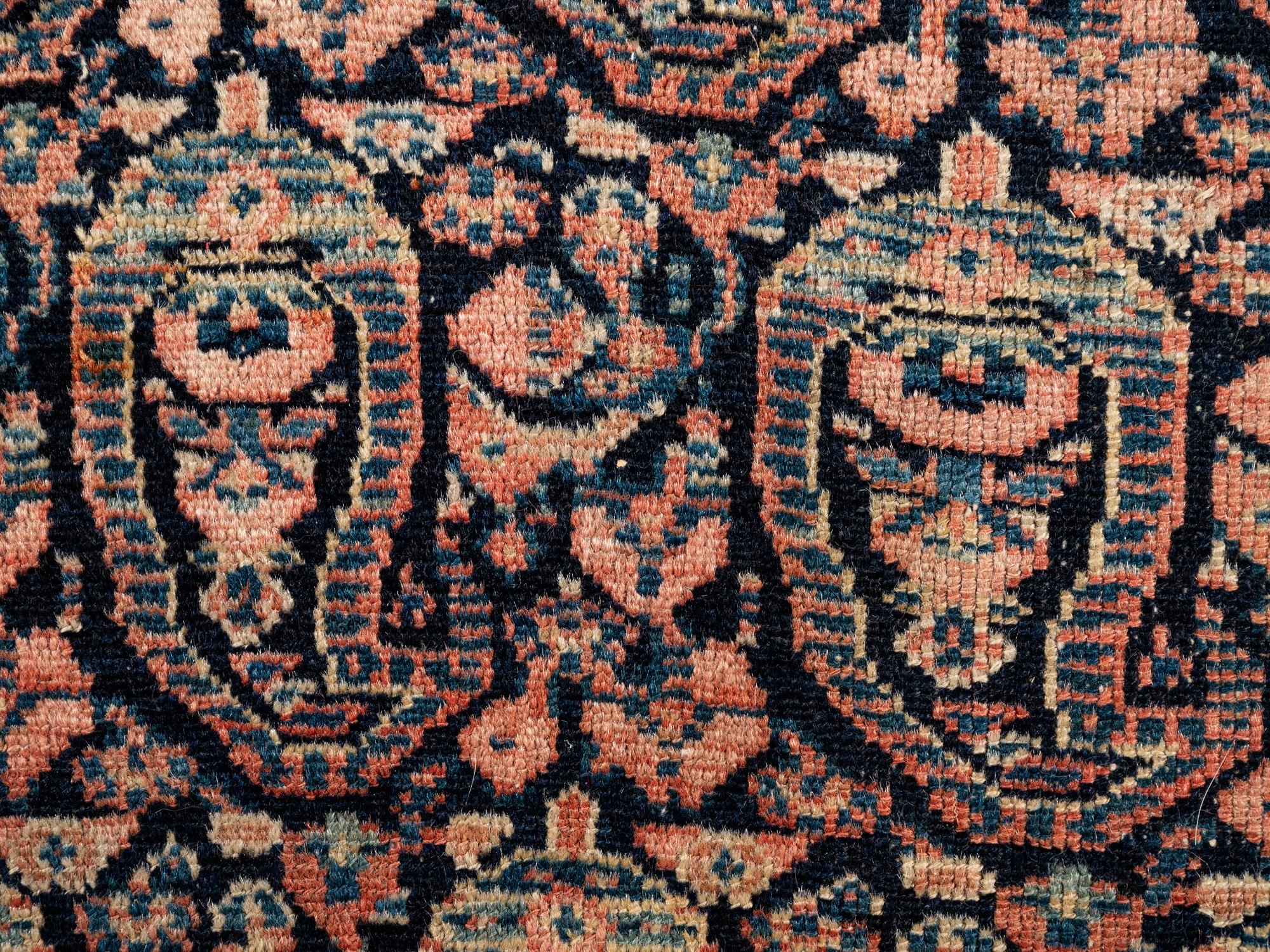 A Persian Senneh Wool Rug