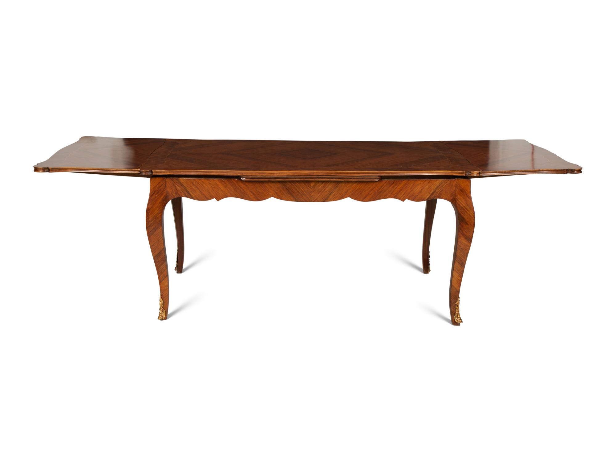 A Louis XV Style Gilt Bronze Mounted Tulipwood and Marquetry Extension Dining Table