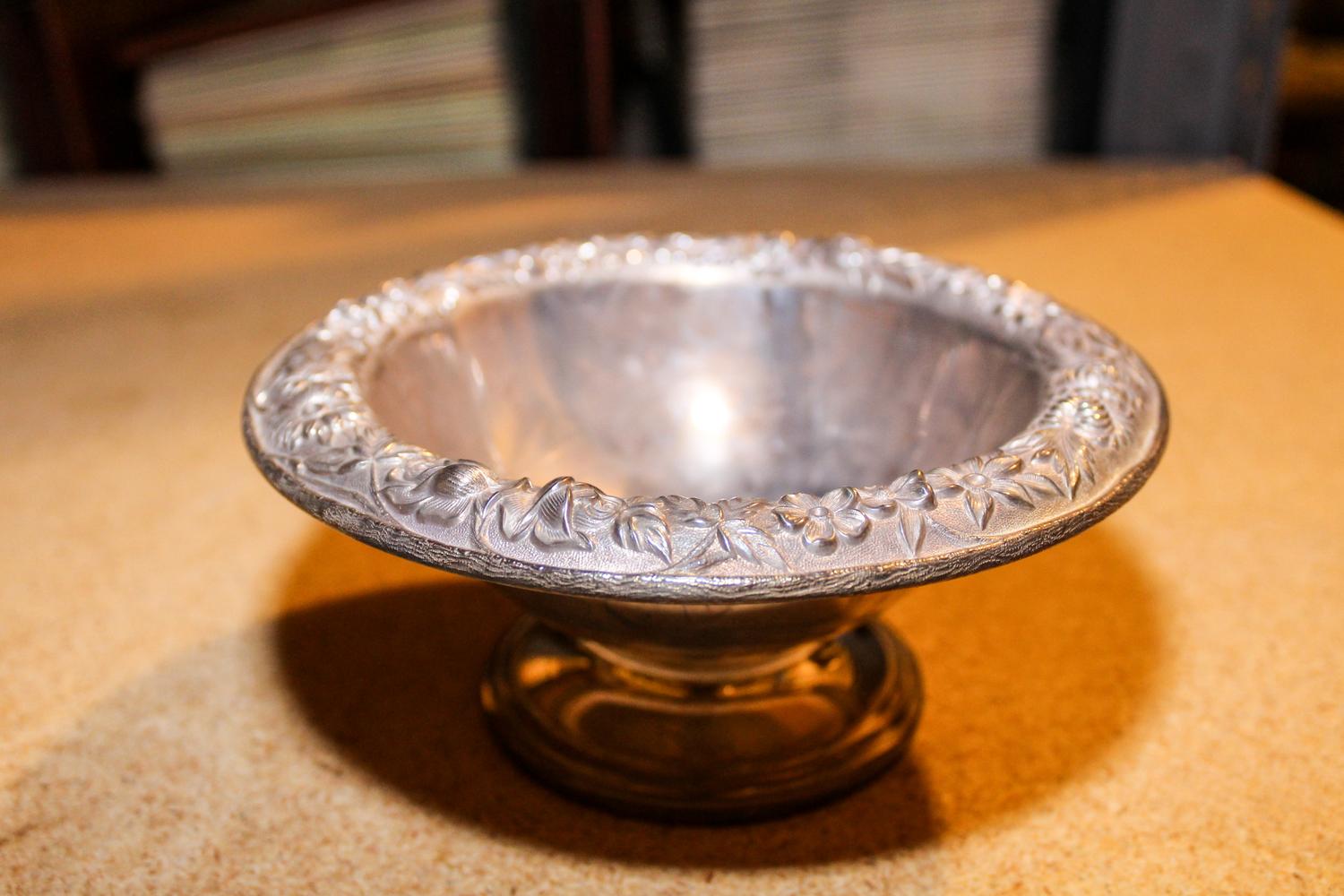 An American Silver Bowl, S. Kirk and Son, Baltimore, MD, the rim decorated with repousse floral and foliate decoration and raised on a