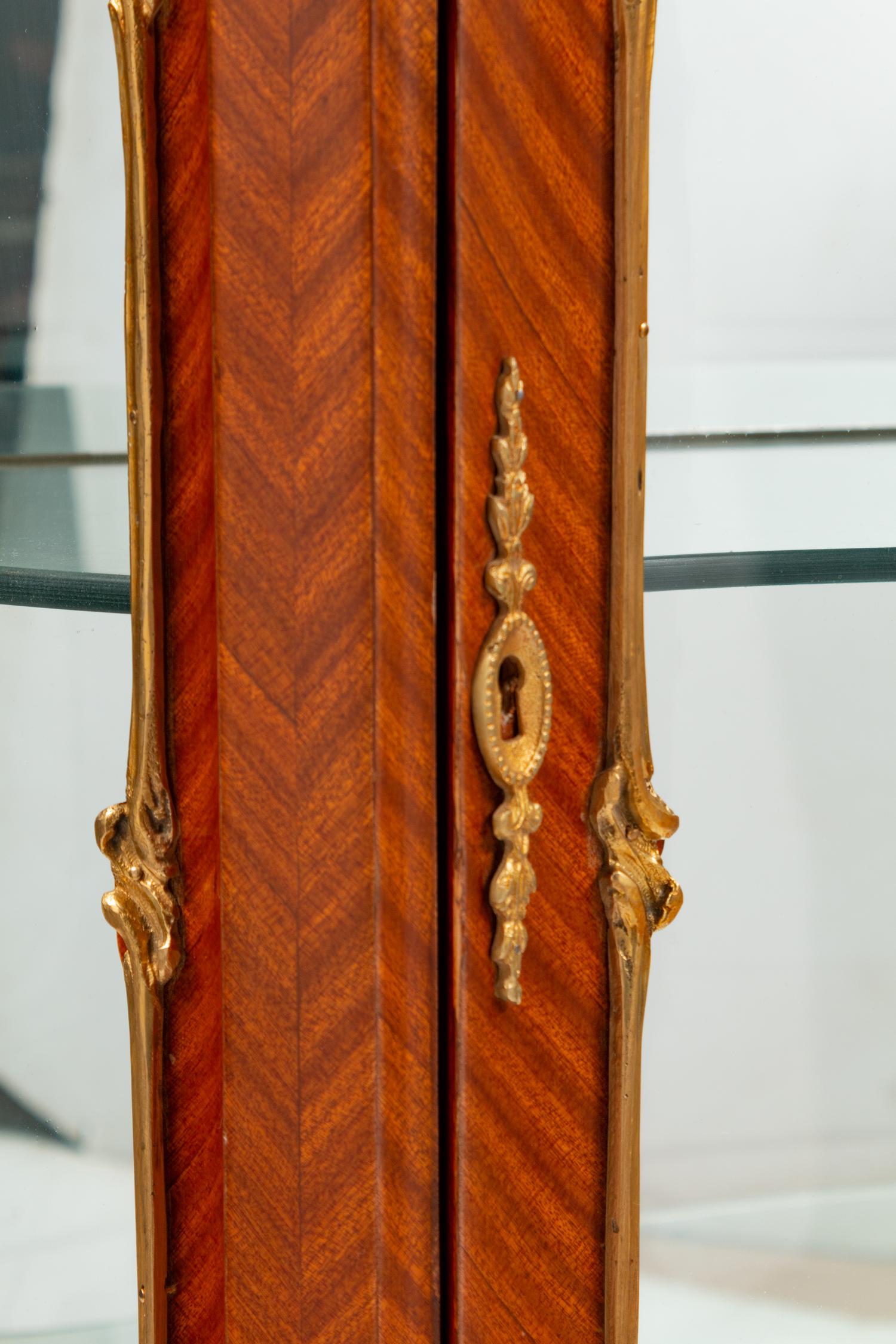 A Pair of Louis XV Style Gilt Metal Mounted Marble-Top Vitrine Cabinets