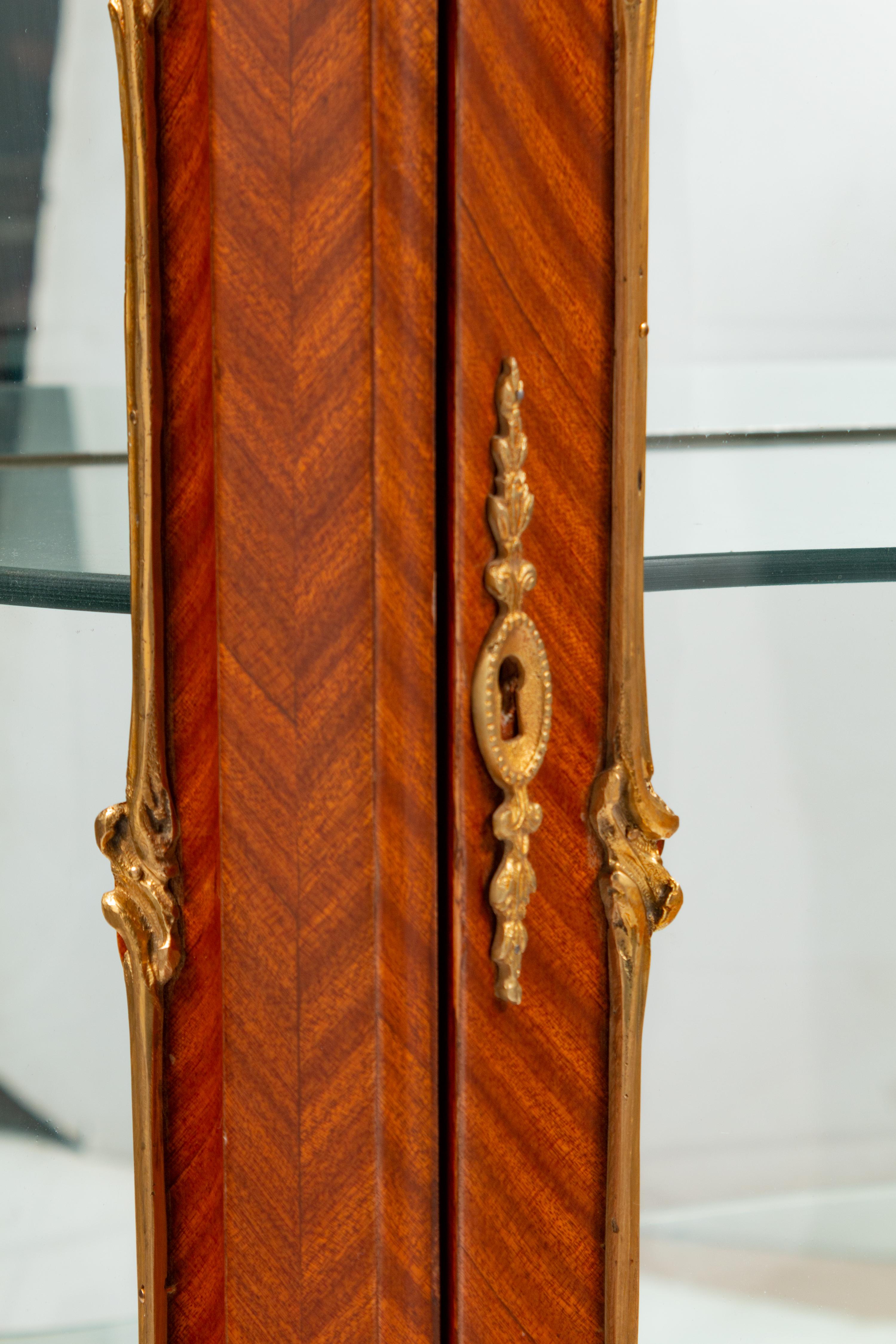 A Pair of Louis XV Style Gilt Metal Mounted Marble-Top Vitrine Cabinets