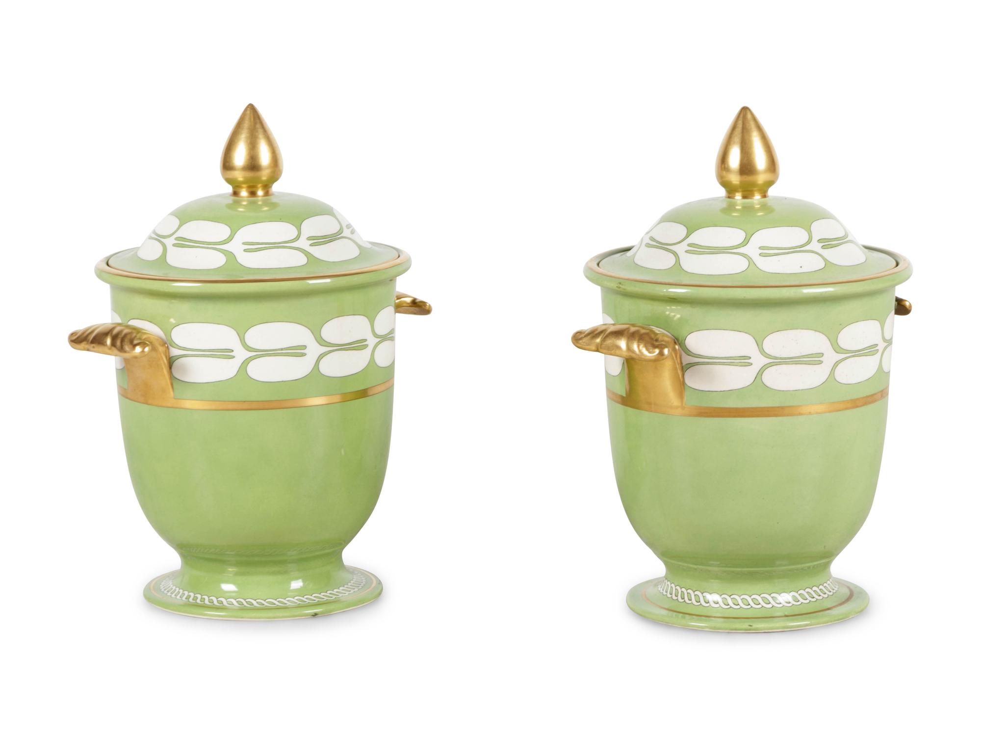 A Pair of Porcelain Covered Urns
