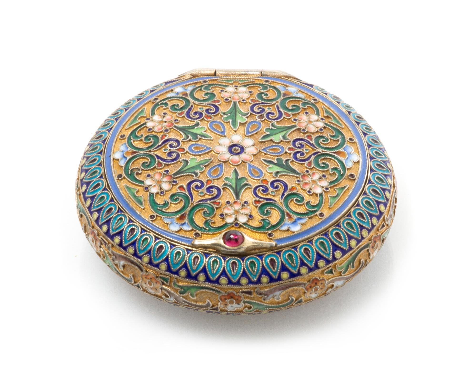 A Russian Enameled Silver Snuff Box, Mark of 11th Artel, Moscow, early 20th century, of circular form, the case having a gilt wash grou