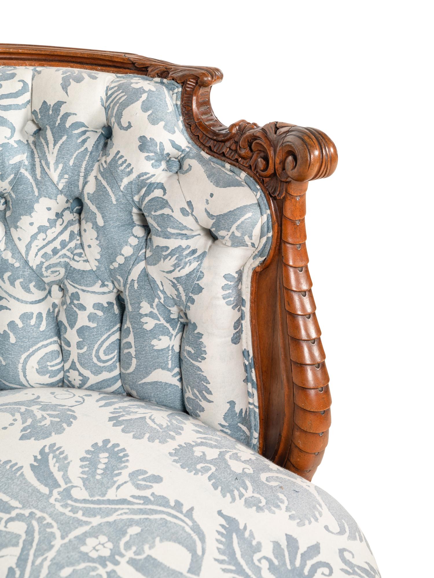 A Rococo Revival Carved Walnut Armchair