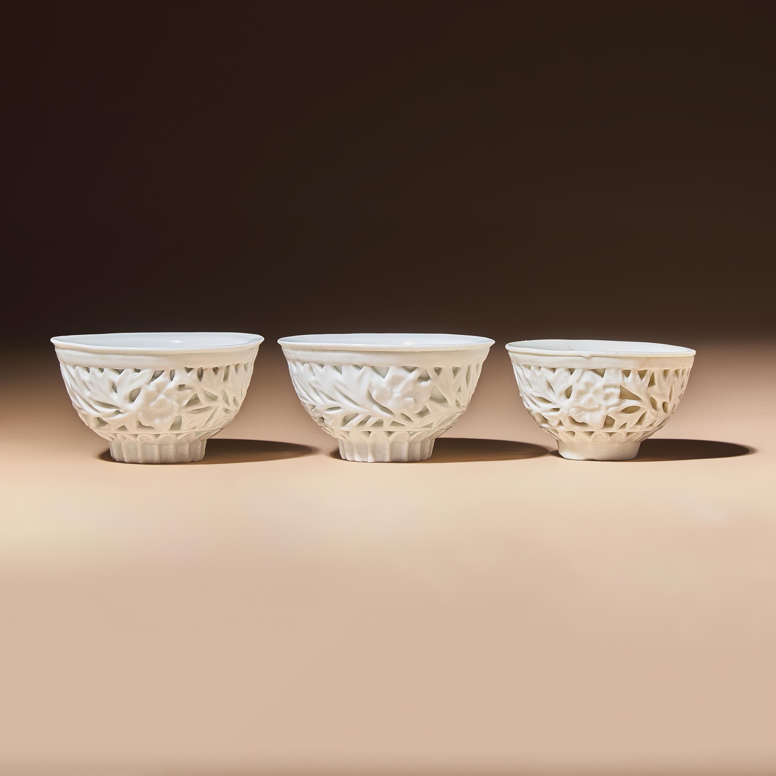 Three Chinese Blanc-de-Chine Porcelain Reticulated 'Floral' Cups, Mid 17th-Early 18th Century — 清中期 德化白瓷鏤雕花卉紋杯三隻