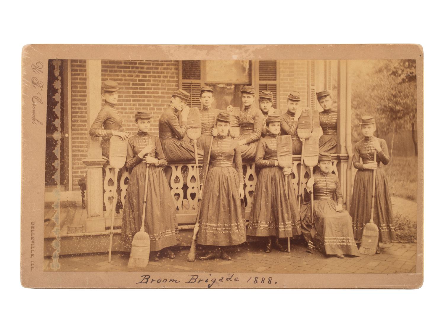 [WOMEN]. Broom Brigade 1888 . Boudoir photograph of an all-female military-style drill team.