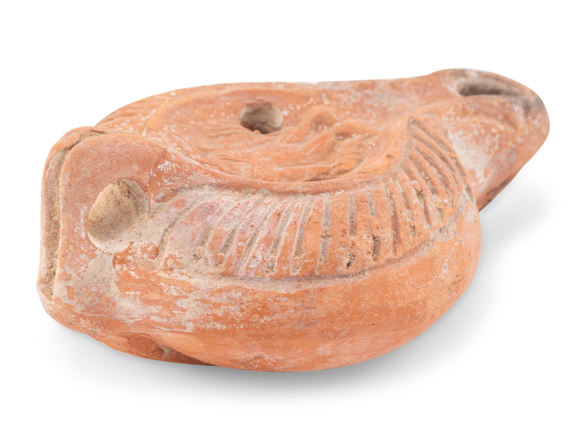 A Roman Terracotta Discus Lamp Depicting the God Hermes