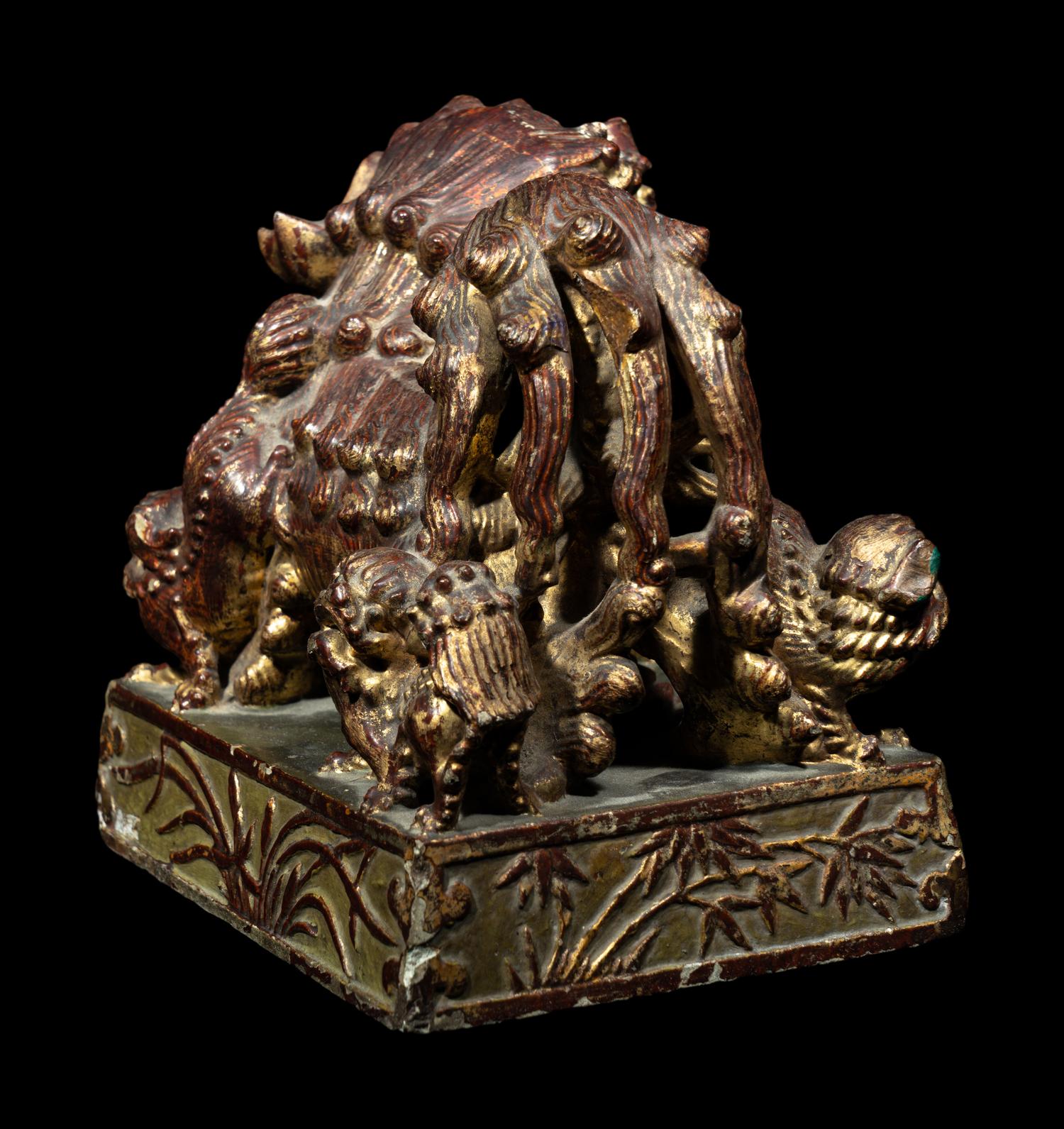 A Chinese Red and Gilt Lacquered Stone 'Buddhist Lion' Paperweight