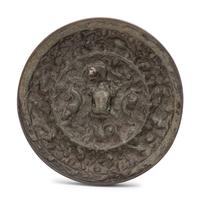 A Chinese Bronze Circular 'Mythical Beasts and Grapes' Mirror