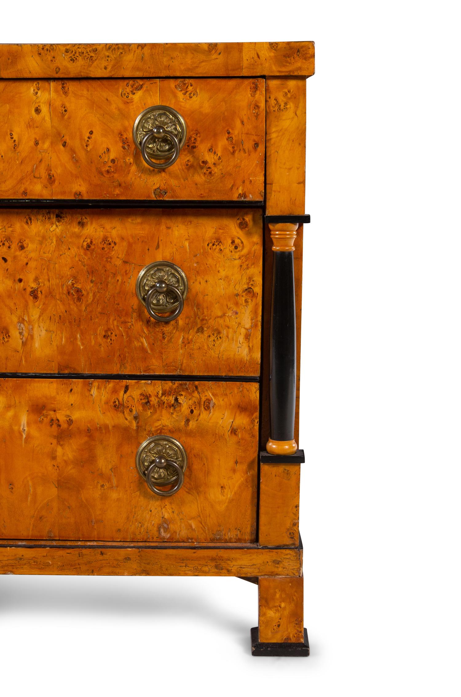 An Austrian or Northern European Parcel Ebonized Burlwood Commode