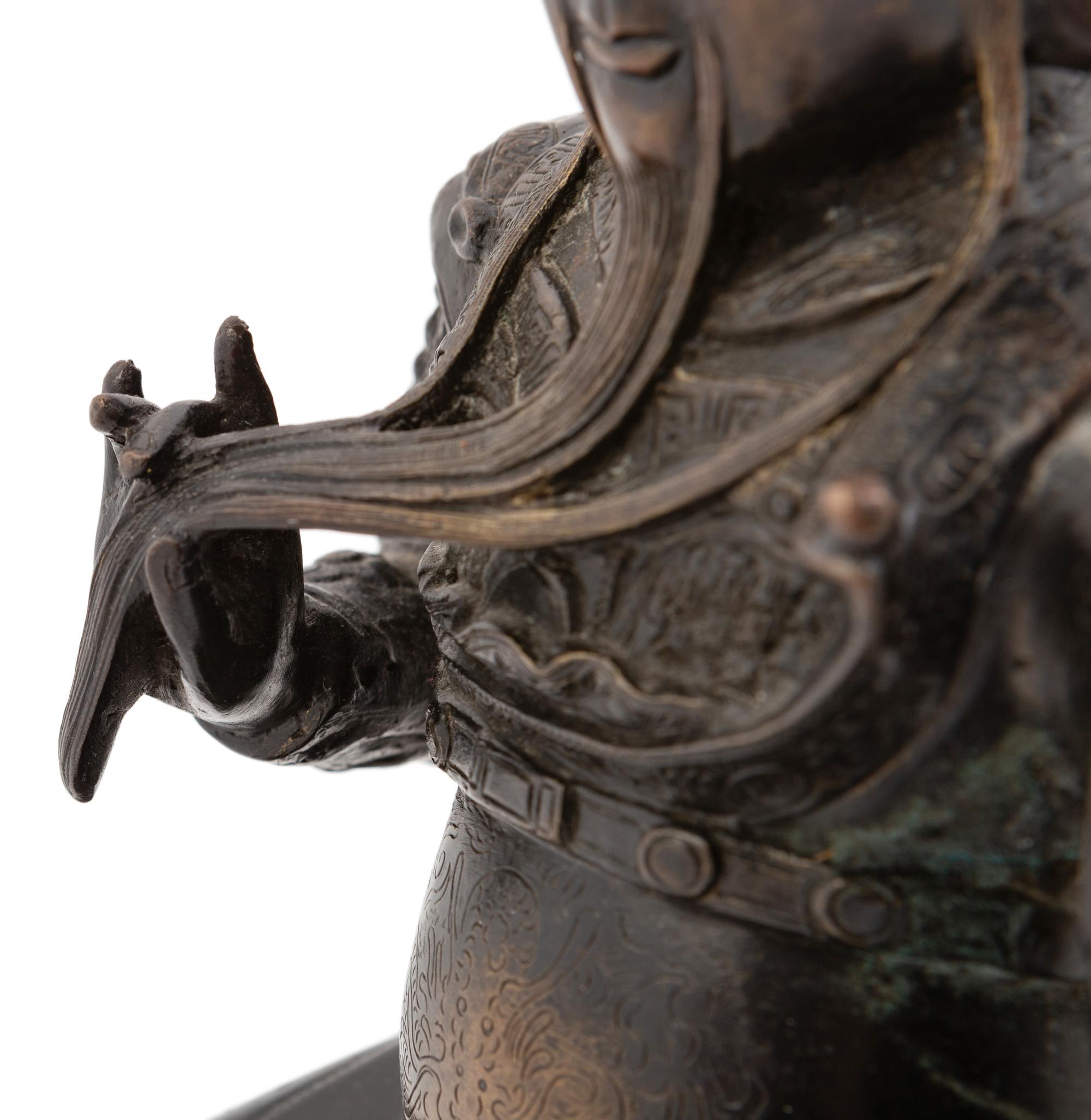 A Chinese Bronze Figure of a Seated Guardian, Guangong