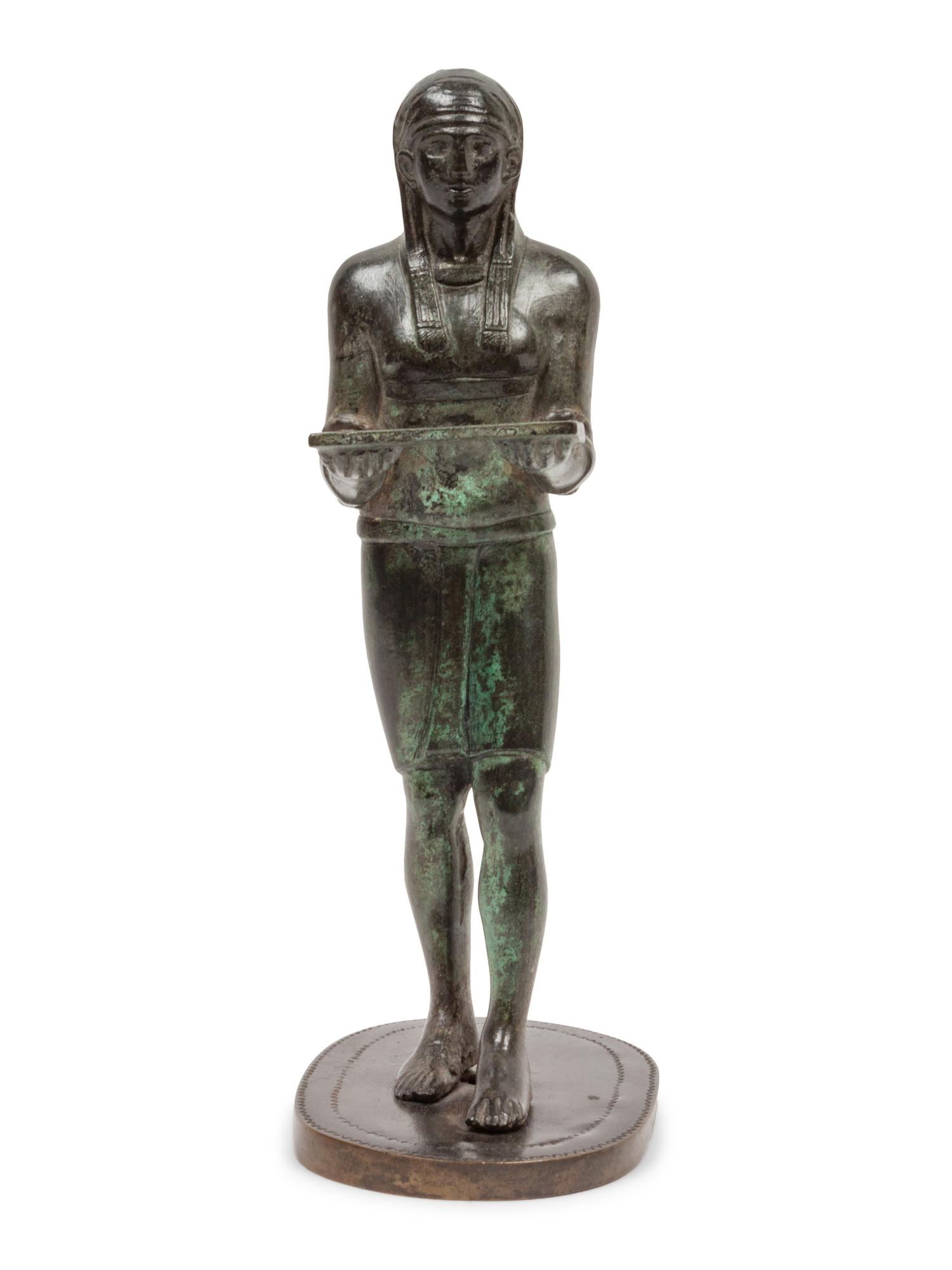 A Patinated Bronze Figure of an Egyptian as an Offering-Bearer