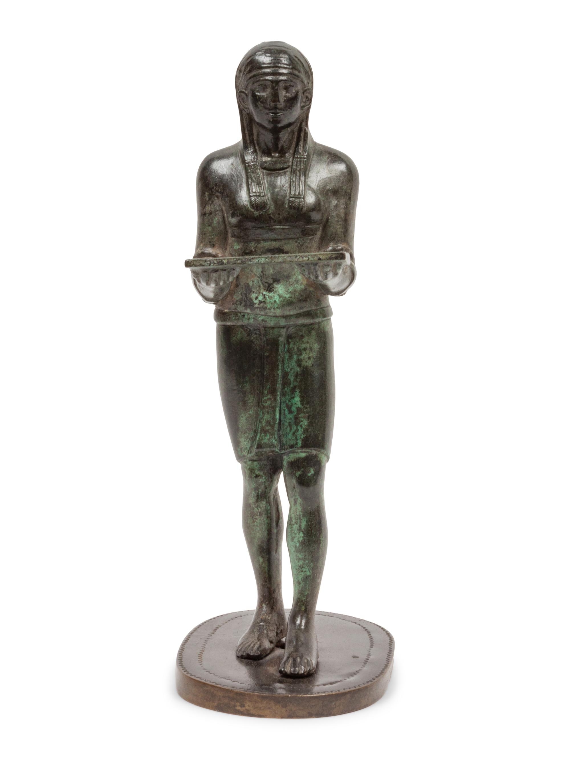 A Patinated Bronze Figure of an Egyptian as an Offering-Bearer